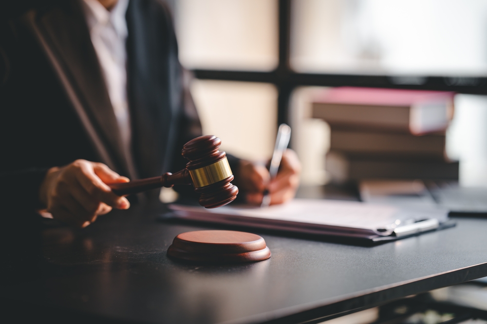 Close-up focussed on the judge hammer on the table. Lawyer. Court judge. Concept of court and justice
